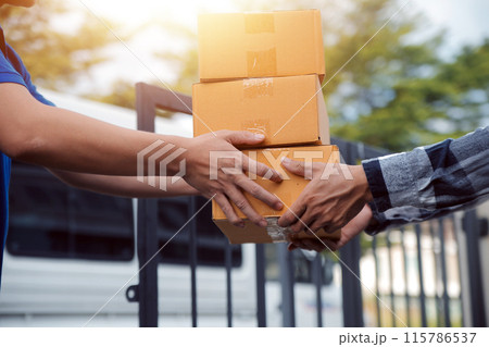 Asian delivery express courier young man use giving boxes to woman customer he wearing protective face mask at front home Asian delivery express courier young man use giving boxes to woman customer he wearing protective face mask at front home 115786537