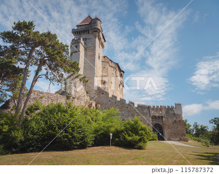 summer trip around Vienna, Austria. Liechtenstein Ancient castle from the 12th century. Historic castle on blue sky background. Liechtenstein, Lower Austria (Located near the Modling city) summer trip around Vienna, Austria. Liechtenstein Ancient castle from the 12th century. Historic castle on blue sky background. Liechtenstein, Lower Austria (Located near the Modling city) 115787372