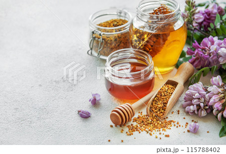 Raw organic bee pollen and honey in jars. 115788402