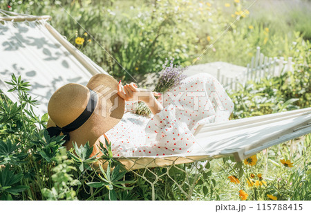 Woman relaxing in a hammock Woman relaxing in a hammock 115788415
