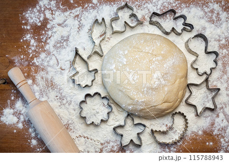 forms for squeezing the dough. dough on the table with dough tools. 115788943