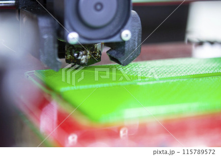 3D printer close up. Working 3D printer close-up. The process of printing on a 3D printer. 3D printer creating an object from molten plastic. 3D printer close up. Working 3D printer close-up. The process of printing on a 3D printer. 3D printer creating an object from molten plastic. 115789572