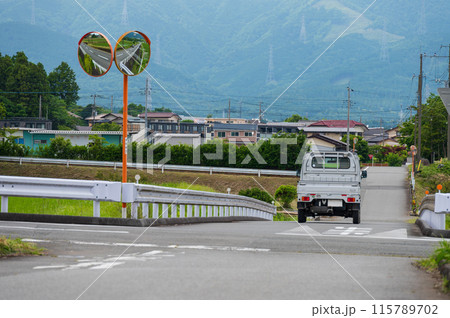 軽トラが走る田舎道　のどかな街町並み 115789702