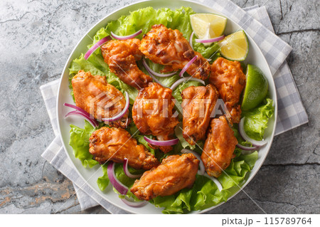 Deep Fried Tom Yam Chicken wings Thai food closeup on the plate. Horizontal top view 115789764