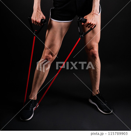 Athletic female performs exercises using a resistance band. Strength and motivation 115789903