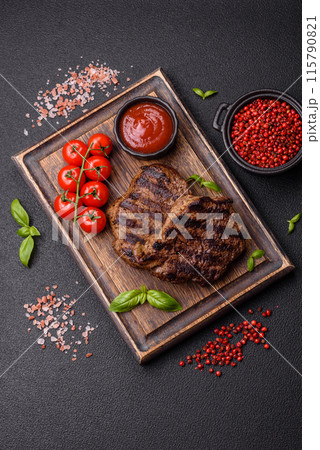 Fresh juicy delicious beef steak on a dark background 115790821