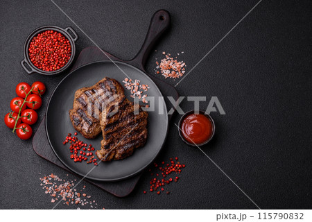 Fresh juicy delicious beef steak on a dark background 115790832