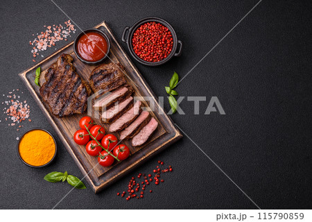 Fresh juicy delicious beef steak on a dark background 115790859