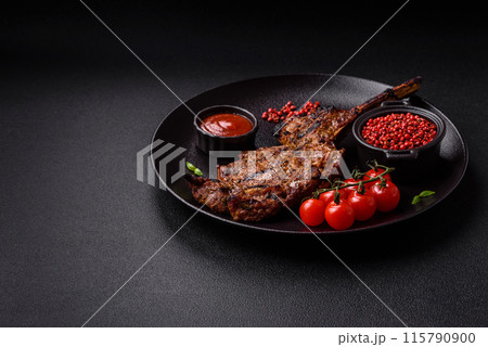 Juicy beef tomahawk steak on the bone baked on the grill Juicy beef tomahawk steak on the bone baked on the grill 115790900