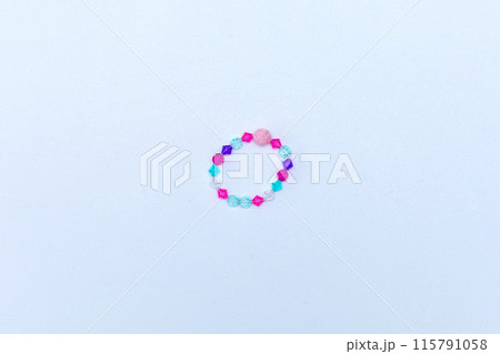 Kids handmade beaded jewelry. Necklaces and bracelets made from multicolored beads and pearls. DIY bracelet beads. Children's needlework. Creativity and hobby. Art activity for kids 115791058