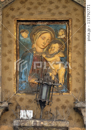 Virgin Mary with baby Jesus, house facade in Modena, Italy Virgin Mary with baby Jesus, house facade in Modena, Italy 115792771