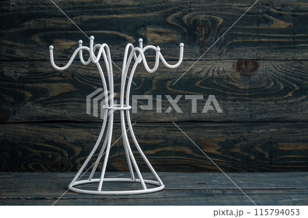 Empty white mug hanger against a blue wooden background with copy space. Empty white mug hanger against a blue wooden background with copy space. 115794053