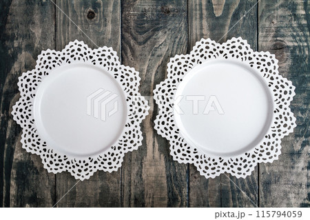 Decorative White Metal Trays on a Dark Wooden Background 115794059