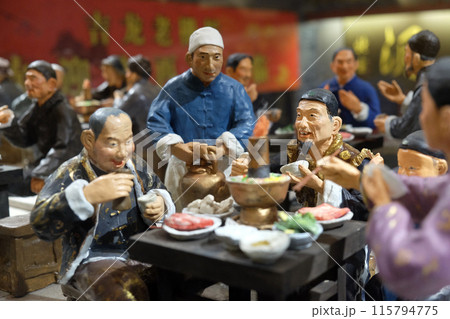 Chinese figures in restaurant at famous Qianmen pedestrian commercial street in Beijing Chinese figures in restaurant at famous Qianmen pedestrian commercial street in Beijing 115794775