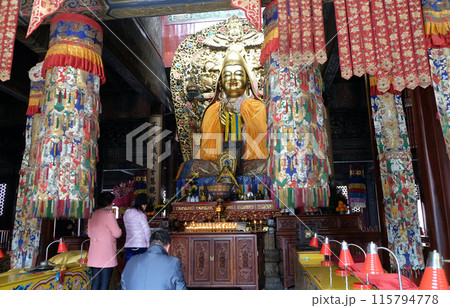 Buddhists worship buddha at the Lama Temple Yonghe Lamasery in Beijing Buddhists worship buddha at the Lama Temple Yonghe Lamasery in Beijing 115794778