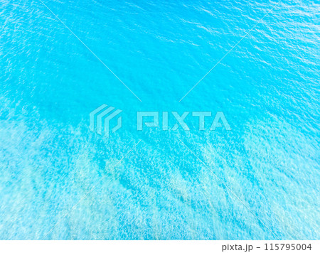 Aerial view of a blue sea surface water texture background,Sun reflections over ocean, Aerial flying drone view Waves water surface texture on sunny tropical ocean in Phuket island Thailand Aerial view of a blue sea surface water texture background,Sun reflections over ocean, Aerial flying drone view Waves water surface texture on sunny tropical ocean in Phuket island Thailand 115795004