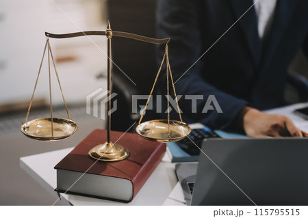Male lawyer working with contract papers and wooden gavel on tabel in courtroom. justice and law ,attorney, court judge, concept. 115795515