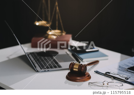 Male lawyer working with contract papers and wooden gavel on tabel in courtroom. justice and law ,attorney, court judge, concept. Male lawyer working with contract papers and wooden gavel on tabel in courtroom. justice and law ,attorney, court judge, concept. 115795518