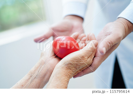 Asian woman doctor holding red heart for health in hospital. 115795614