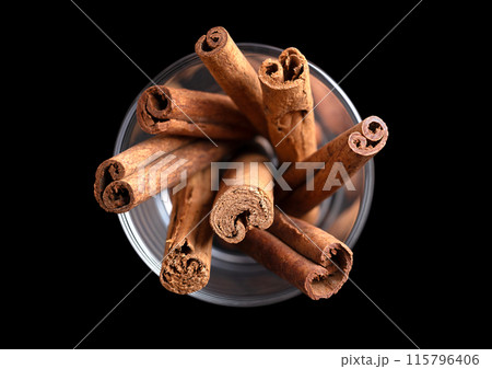Cinnamon bark in a glass from above. Sticks of raw bark of Ceylon and Indonesian cinnamon, Cinnamomum verum and C. burmanni. Used as aromatic condiment and flavouring additive in a wide variety. Cinnamon bark in a glass from above. Sticks of raw bark of Ceylon and Indonesian cinnamon, Cinnamomum verum and C. burmanni. Used as aromatic condiment and flavouring additive in a wide variety. 115796406