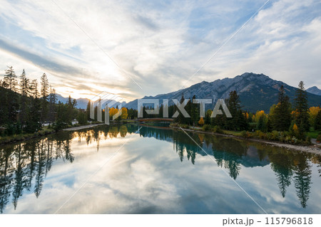 Banff National Park in autumn. Beautiful natural scenery reflected on Bow River like a mirror. Mount Norquay, Town of Banff, Canadian Rockies. Banff National Park in autumn. Beautiful natural scenery reflected on Bow River like a mirror. Mount Norquay, Town of Banff, Canadian Rockies. 115796818