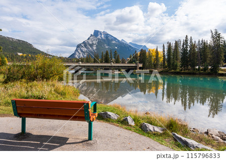 Banff Central Park Trail scenery reflected on Bow River in autumn. Mount Rundle Mountain Range in the background. Banff National Park, Alberta, Canada. Banff Central Park Trail scenery reflected on Bow River in autumn. Mount Rundle Mountain Range in the background. Banff National Park, Alberta, Canada. 115796833