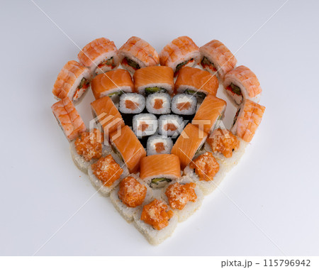 Heart shaped set of sushi rolls for Valentine's Day. Menu or delivery concept, Top view 115796942