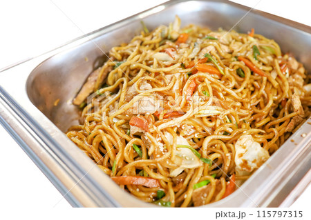 Top view of soba noodles, stir fried soy sauce in stainless steel countertop, focus selective 115797315