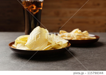 Potato chips, French fries snack and a glass of cola. Food and drink concept. 115798344