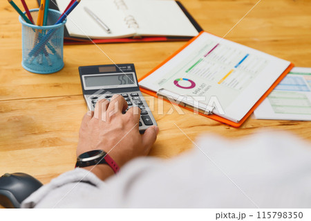 Financial businessman accounting calculating cost economic budget in home office. Investment and saving concept. 115798350