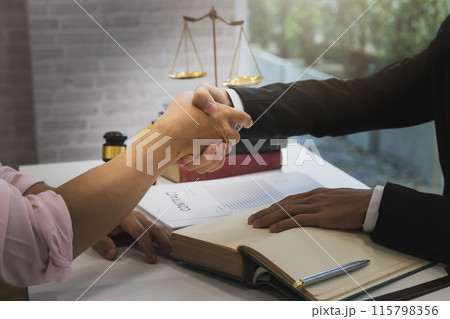 The lawyer shook hands with the client after completing the consultation in the case. The lawyer shook hands with the client after completing the consultation in the case. 115798356