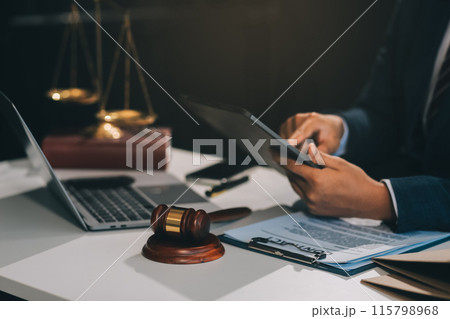 Male lawyer working with contract papers and wooden gavel on tabel in courtroom. justice and law ,attorney, court judge, concept. 115798968