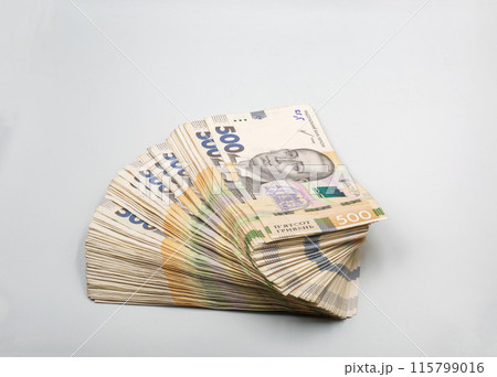 Ukrainian hryvna currency notes heap closeup on white. 115799016