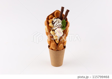 Hong kong or bubble waffle with ice cream and fruits isolated on white background Hong kong or bubble waffle with ice cream and fruits isolated on white background 115799468
