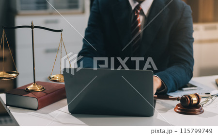 Male lawyer working with contract papers and wooden gavel on tabel in courtroom. justice and law ,attorney, court judge, concept. Male lawyer working with contract papers and wooden gavel on tabel in courtroom. justice and law ,attorney, court judge, concept. 115799749
