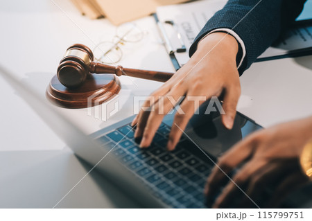 Male lawyer working with contract papers and wooden gavel on tabel in courtroom. justice and law ,attorney, court judge, concept. Male lawyer working with contract papers and wooden gavel on tabel in courtroom. justice and law ,attorney, court judge, concept. 115799751