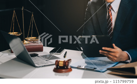 Male lawyer working with contract papers and wooden gavel on tabel in courtroom. justice and law ,attorney, court judge, concept. Male lawyer working with contract papers and wooden gavel on tabel in courtroom. justice and law ,attorney, court judge, concept. 115799759