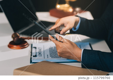 Male lawyer working with contract papers and wooden gavel on tabel in courtroom. justice and law ,attorney, court judge, concept. 115799760