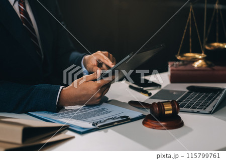 Male lawyer working with contract papers and wooden gavel on tabel in courtroom. justice and law ,attorney, court judge, concept. 115799761