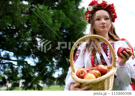 Ukrainian girl apples young woman in traditional Russian clothes with a basket of apples in hands forest. Slow motion Ukrainian girl apples young woman in traditional Russian clothes with a basket of apples in hands forest. Slow motion 115800306