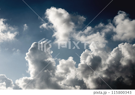 White curly clouds of strange shape in the blue sky on sunny weather. Feeling of an approaching thunderstorm White curly clouds of strange shape in the blue sky on sunny weather. Feeling of an approaching thunderstorm 115800343