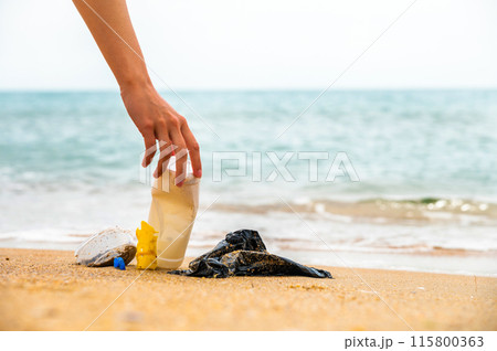 Environment, Ecology Care, Renewable Concept. Volunteer or Traveller Collecting Plastic Bottle Waste on the Beach Sand. Keep Beach Clean 115800363
