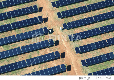Aerial view of large sustainable electrical power plant with rows of solar photovoltaic panels for producing clean electric energy. Concept of renewable electricity with zero emission Aerial view of large sustainable electrical power plant with rows of solar photovoltaic panels for producing clean electric energy. Concept of renewable electricity with zero emission 115800608