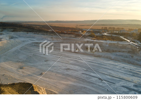 Aerial view of open pit mine of sandstone materials for construction industry with excavators and dump trucks. Heavy equipment in mining and production of useful minerals concept Aerial view of open pit mine of sandstone materials for construction industry with excavators and dump trucks. Heavy equipment in mining and production of useful minerals concept 115800609