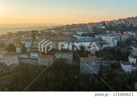 Aerial view of dense historic center of Thiers town in Puy-de-Dome department, Auvergne-Rhone-Alpes region in France. Rooftops of old buildings and narrow streets at sunset Aerial view of dense historic center of Thiers town in Puy-de-Dome department, Auvergne-Rhone-Alpes region in France. Rooftops of old buildings and narrow streets at sunset 115800621