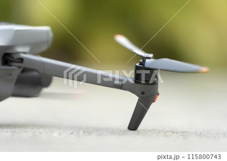 Closeup of motor and propeller of drone for taking video and pictures. Preflight checking of before takeoff Closeup of motor and propeller of drone for taking video and pictures. Preflight checking of before takeoff 115800743