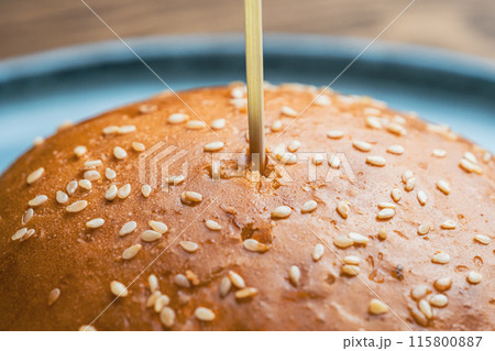 Sesame seed bun with a wooden skewer stick Sesame seed bun with a wooden skewer stick 115800887