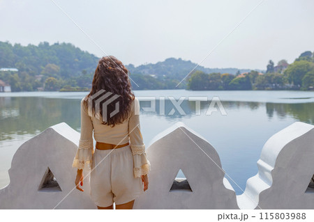 Woman Enjoying Serene Lake View in Kandy, Sri Lanka Woman Enjoying Serene Lake View in Kandy, Sri Lanka 115803988