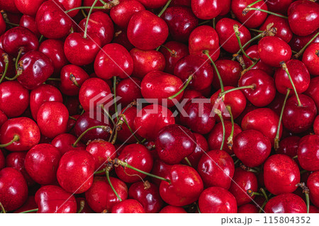 ripe cherries in a plastic box on the table top view background 115804352