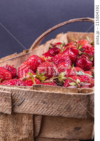 ripe strawberries in a wooden box on the table close up ripe strawberries in a wooden box on the table close up 115804391